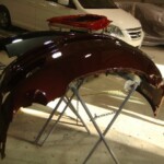 Before and after photographs of a damaged Porsche that was repaired by Elite Paint & Body Shop in West Palm Beach, Florida.